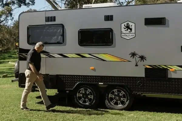 Man preparing a caravan for towing, representing Smarter Towing’s reliable monitoring technology for safe and worry-free RV travel.