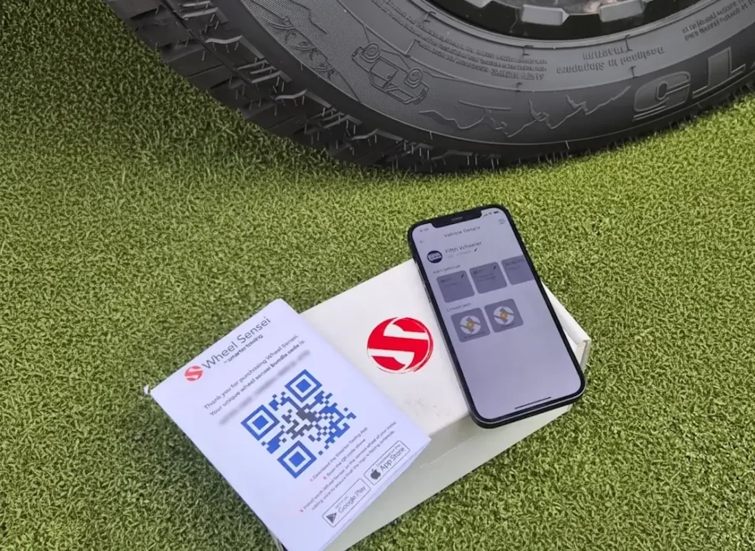 Smartphone scanning Wheel Sensei bundle QR code using the Smarter Towing App to connect trailer sensors