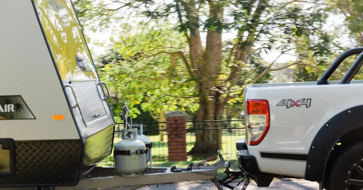 Vehicle towing a caravan illustrating proper towing setup for safe road trips